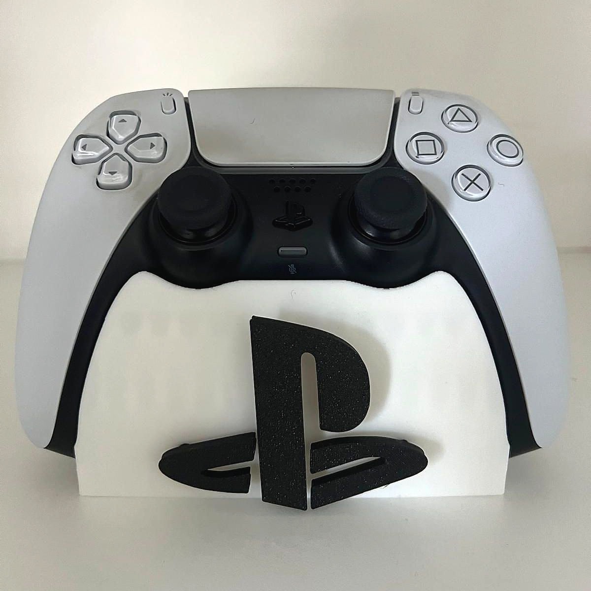A white stand holding a game controller upright